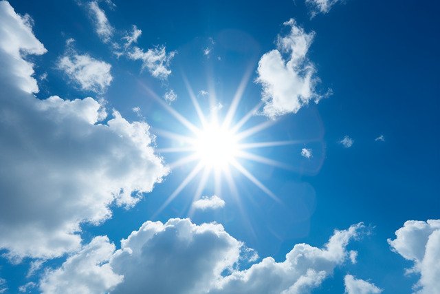 pngtree-a-sun-shining-through-clouds-in-a-bright-blue-sky-image_13112416